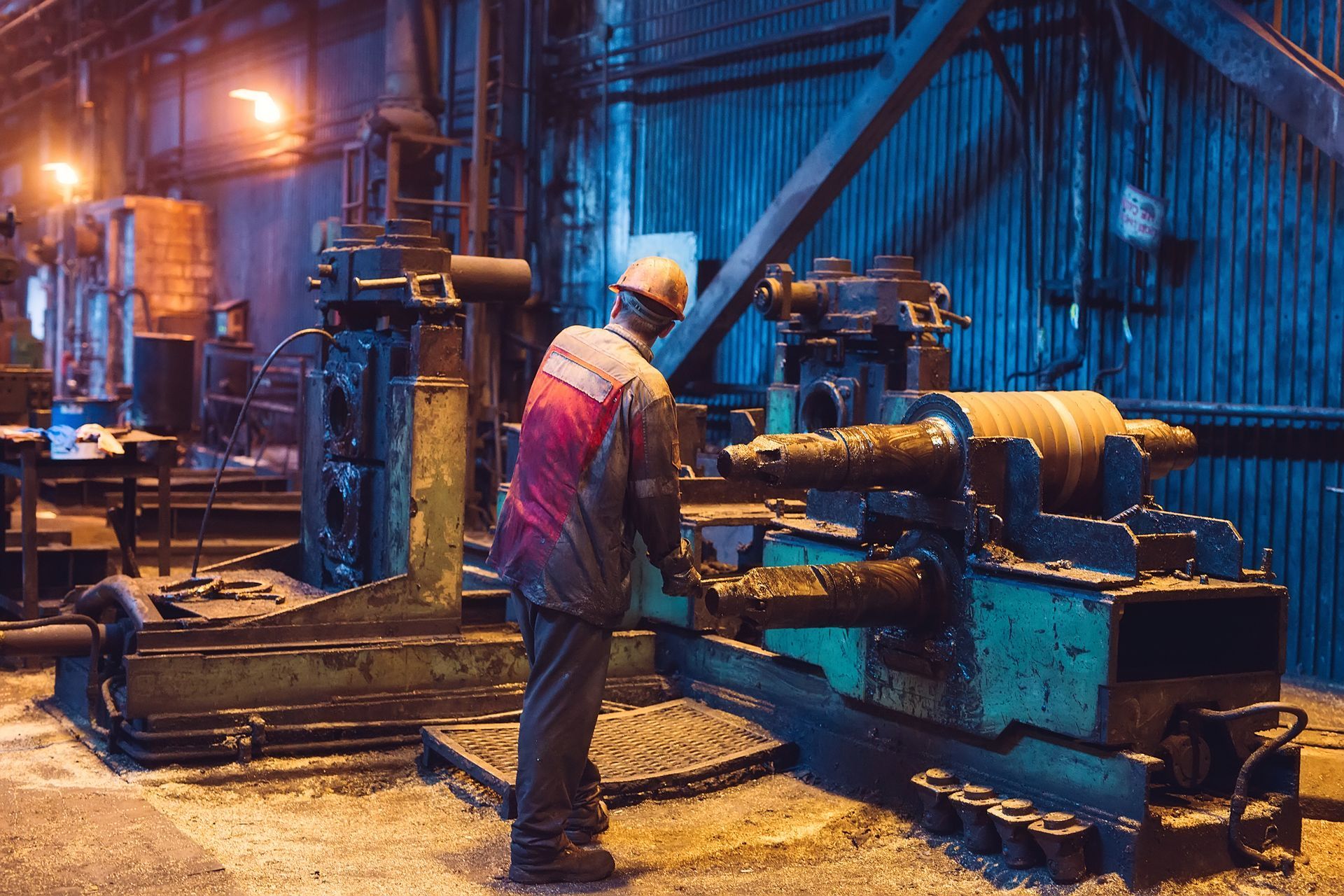 A man is working on a machine in a factory.