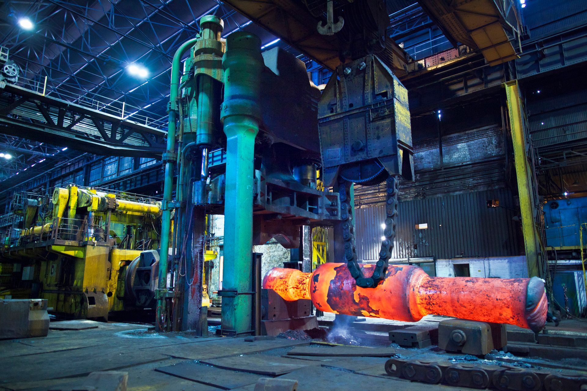 A large piece of metal is being processed in a factory.