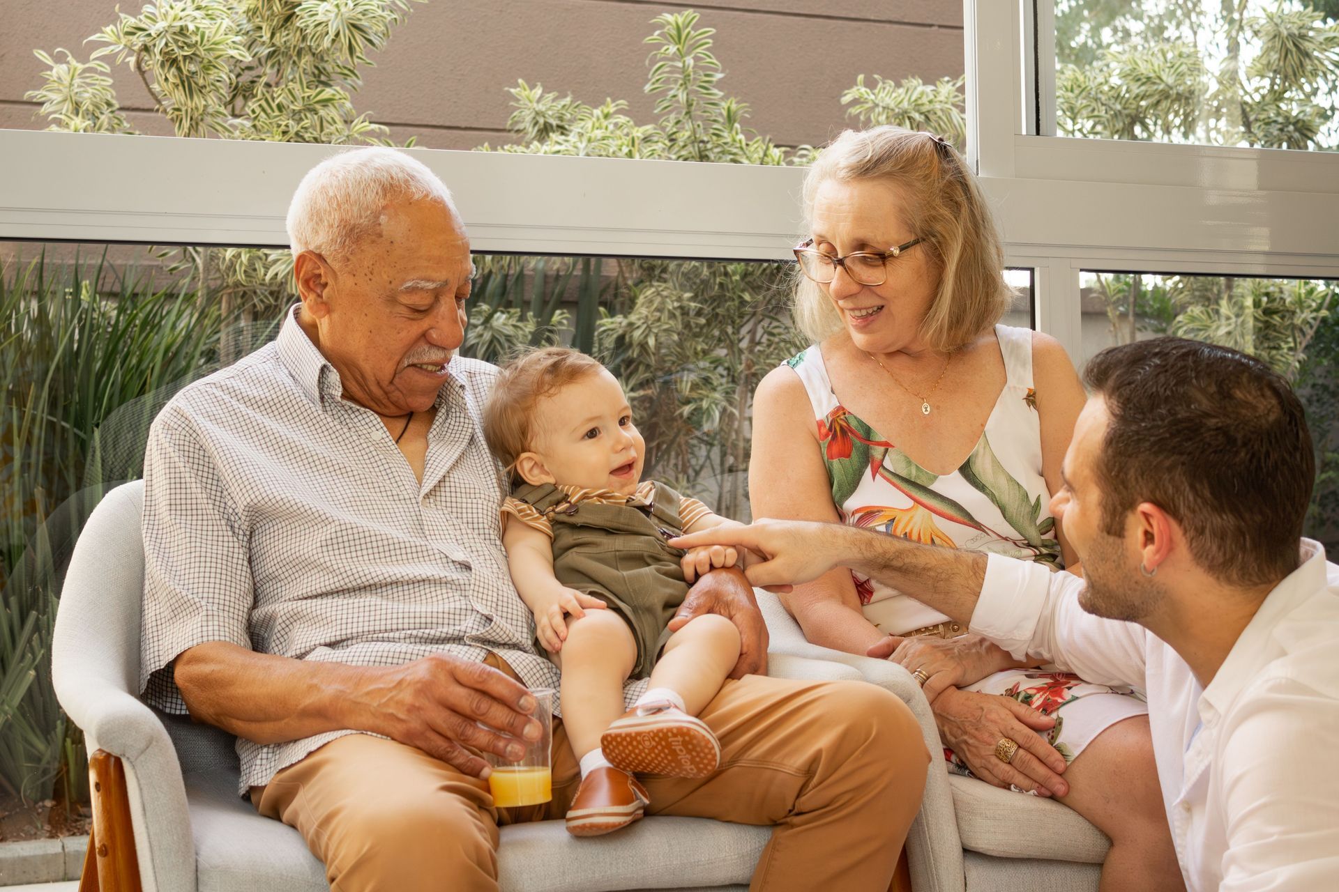 Family chatting together on a couch in a bright living room