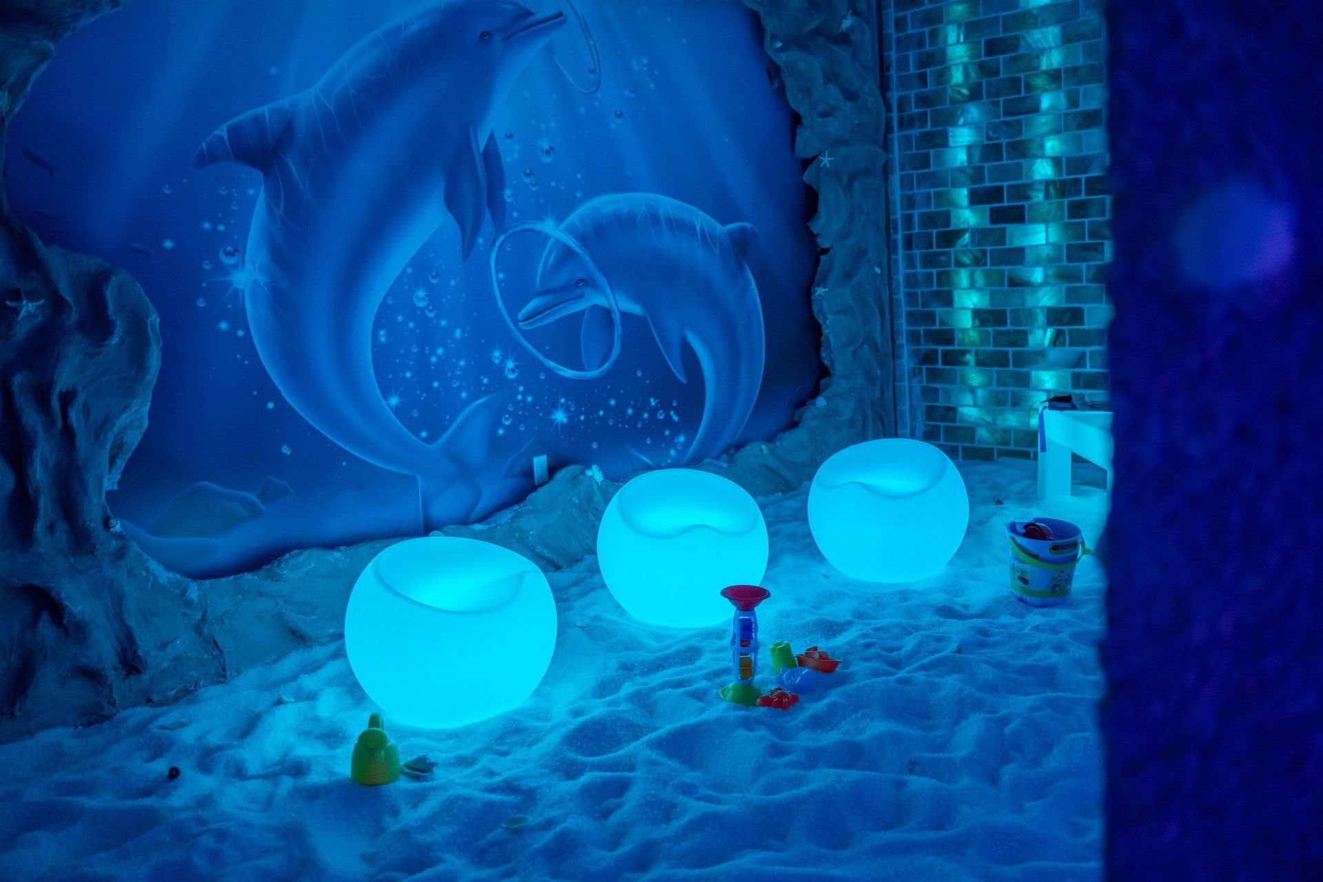 Blue-lit icy room with glowing snowballs and a frosty spiral wall decoration