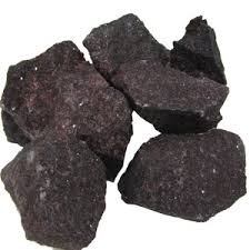 Four dark black coal rocks on a white background