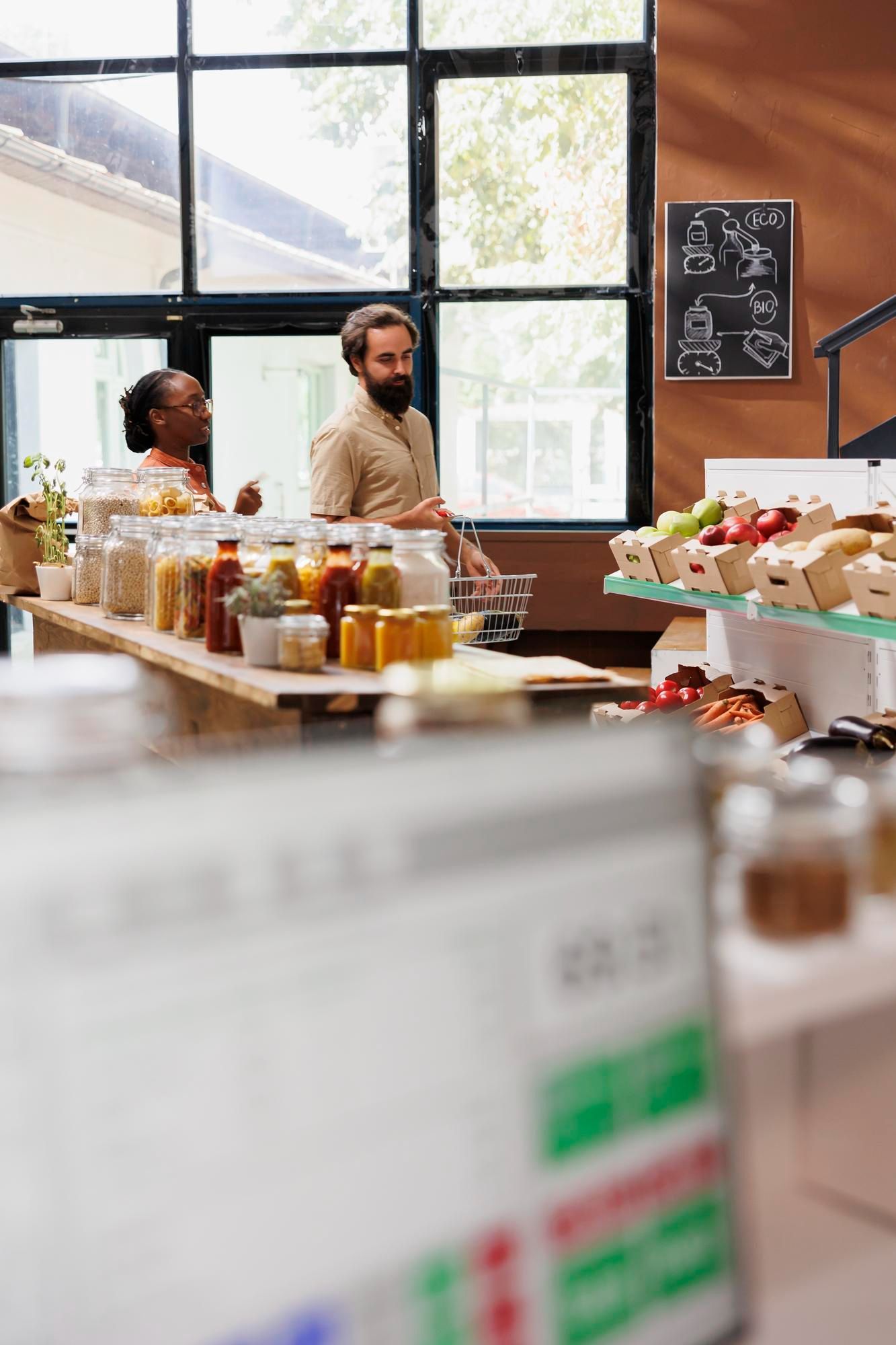 People shopping in a natural food store, selecting items.