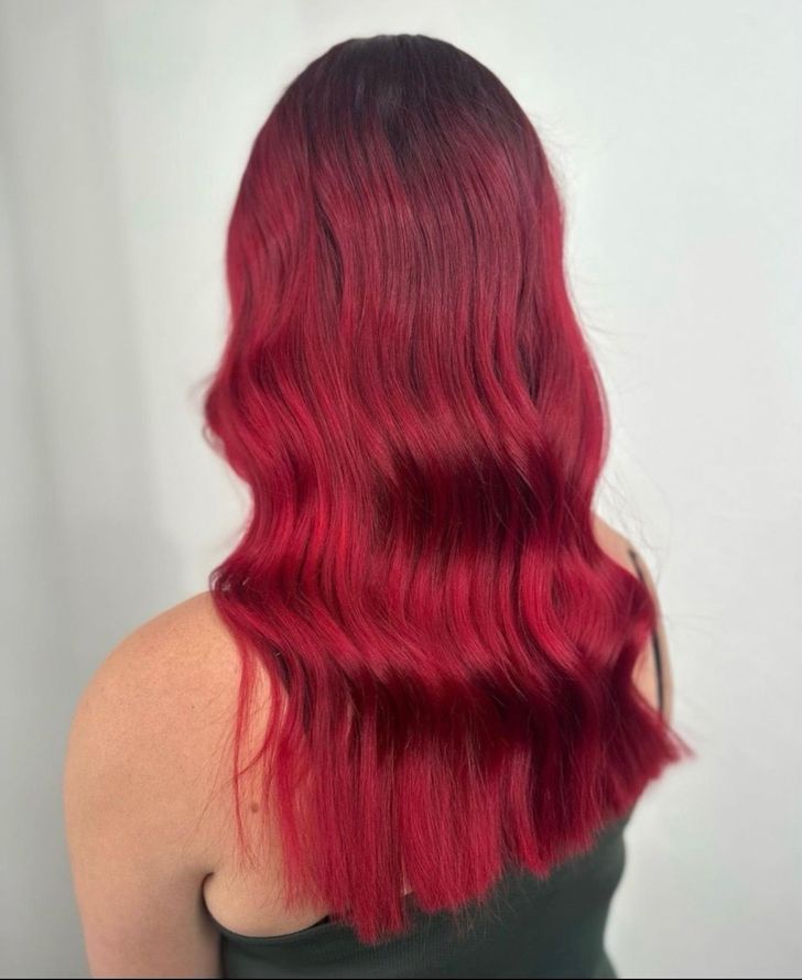 A Woman With Long Blonde Hair Is Standing In A Room — Freedom Hairdressing In Casino, NSW