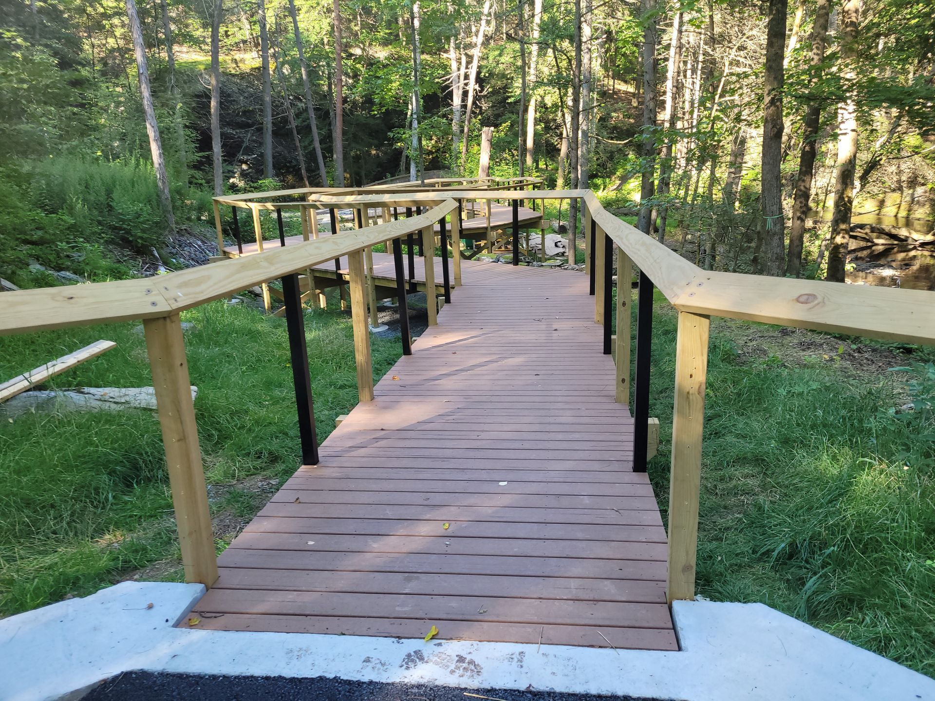 A wooden bridge in the middle of a forest.