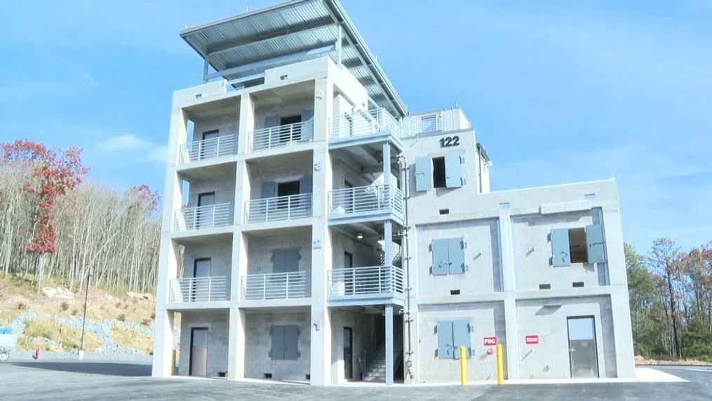 A large building with a lot of windows and balconies is being built.