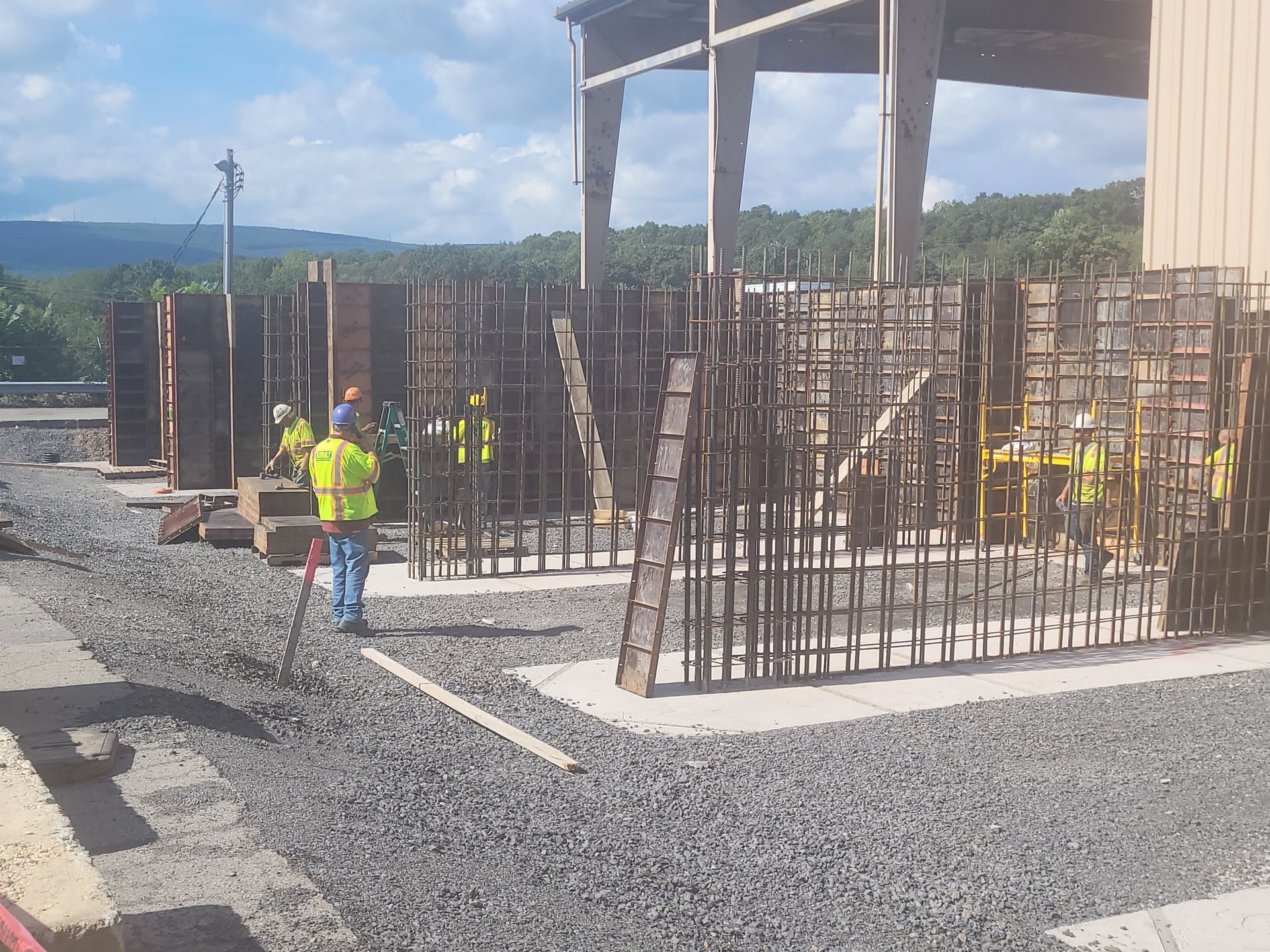 A group of construction workers are working on a building with Kobalt Construction