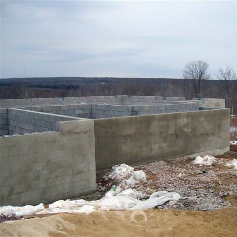 A brick wall is being built in the snow