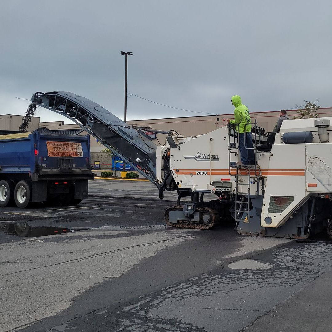 A dump truck with a sign that says ' asphalt ' on it