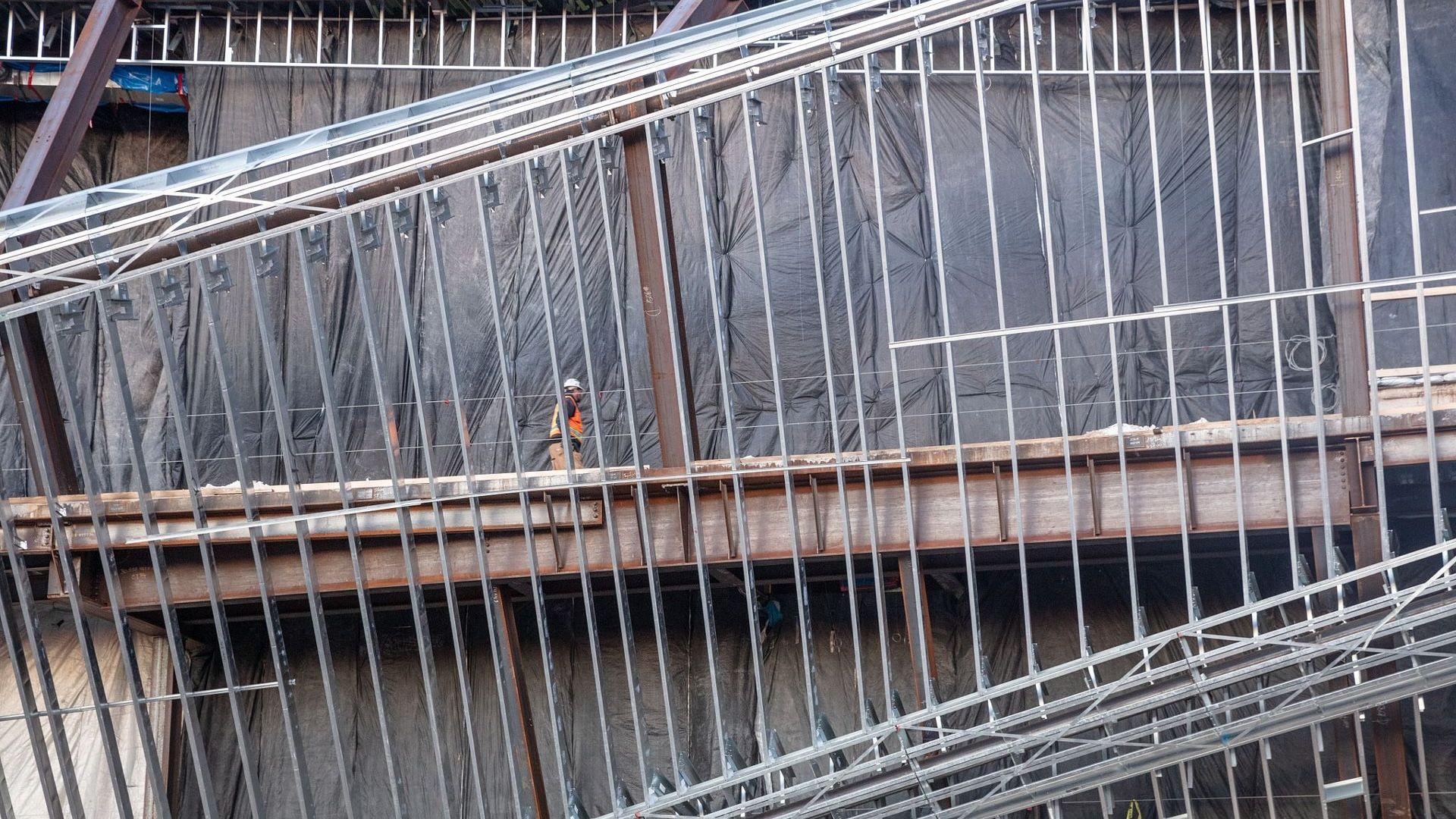 A close up of a metal fence on a building under construction. A close up of a metal fence on a building under construction.