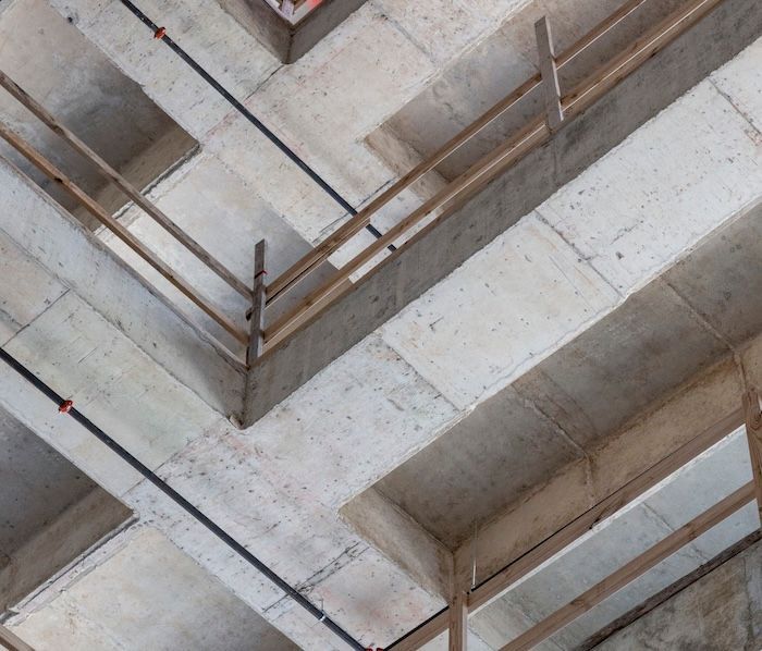 The ceiling of a building under construction with a wooden railing The ceiling of a building under construction with a wooden railing
