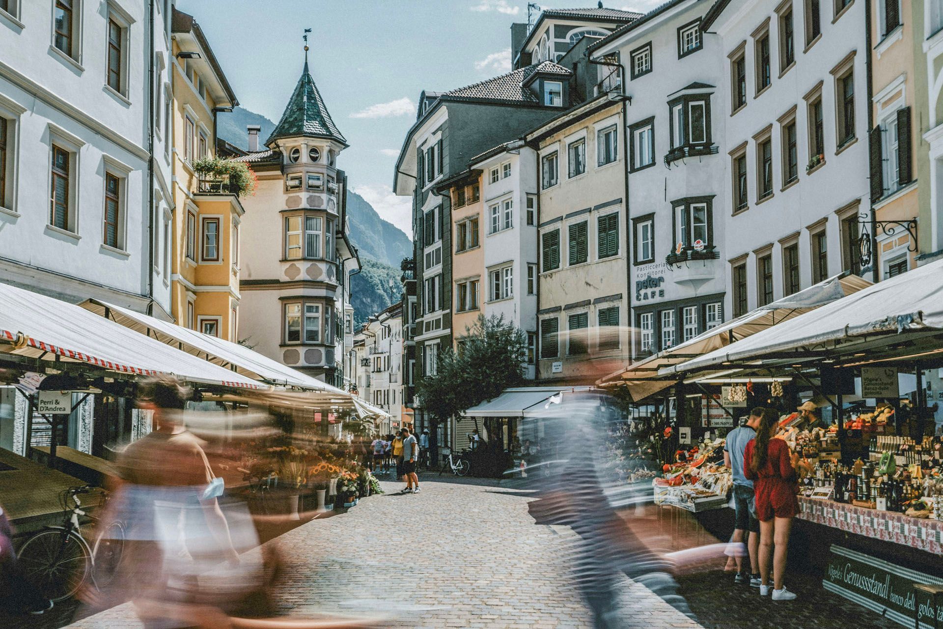 Ein verschwommenes Bild von Menschen, die eine Straße in einer Stadt entlanggehen.