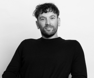 Black and white studio photo of board member Dylan.