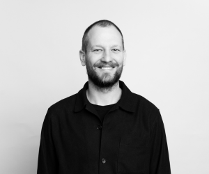 Black and white studio photo of board member Zack
