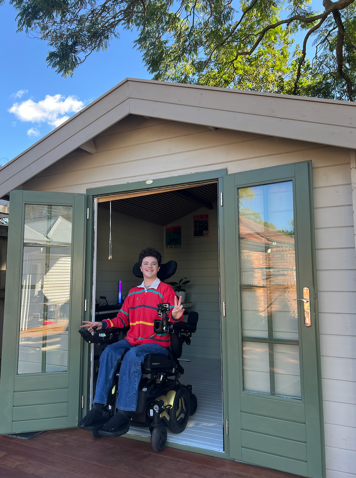 Campbell pictured in the doorway of an at home studio. Cam is a wheelchair user.