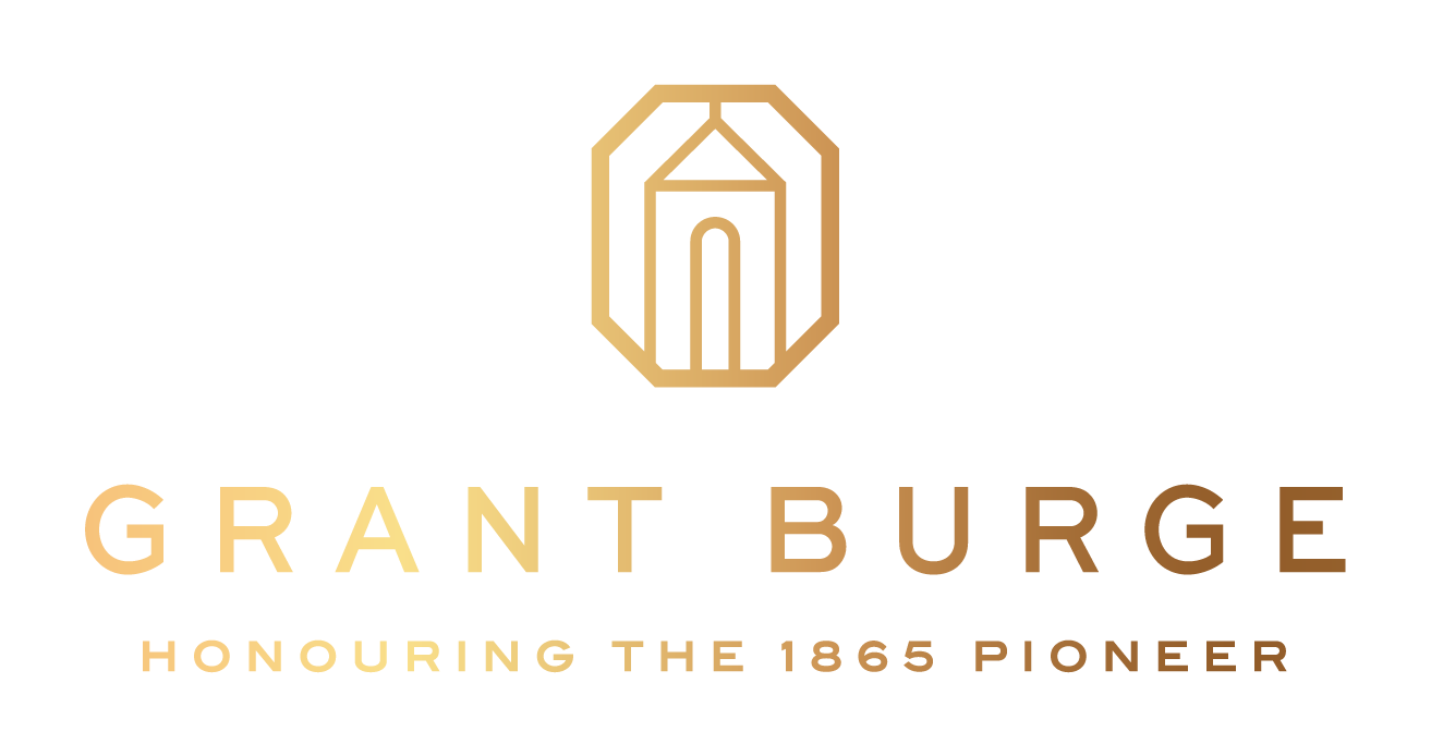 Grant Burge logo in gold with stylized emblem and tagline “Honouring the 1865 Pioneer”