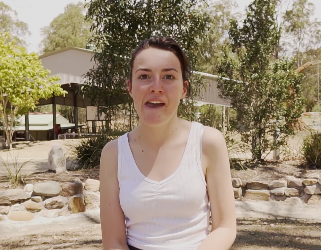 Recipient Breagh sits outside and smiles to camera.