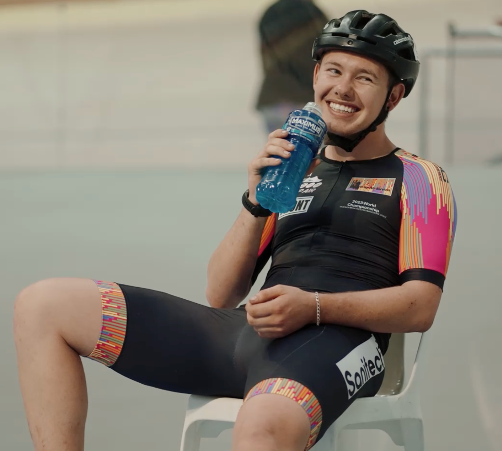 Recipient Tyler wearing lycra, smiling about to drink from water bottle.