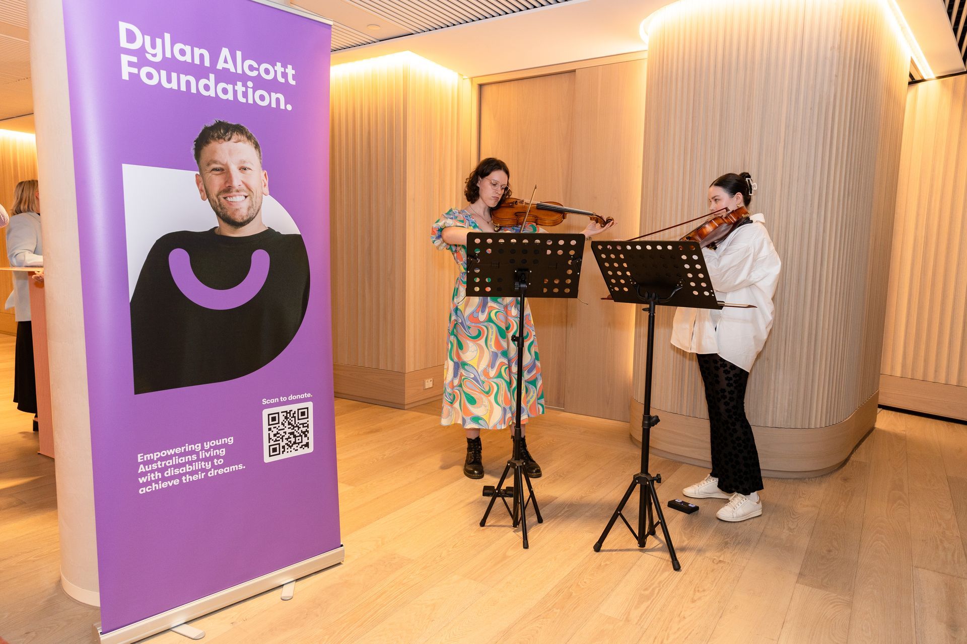 Recipient Sophia and her friend Helena perform the Viola whilst a DAF stand is shown to the left of them.