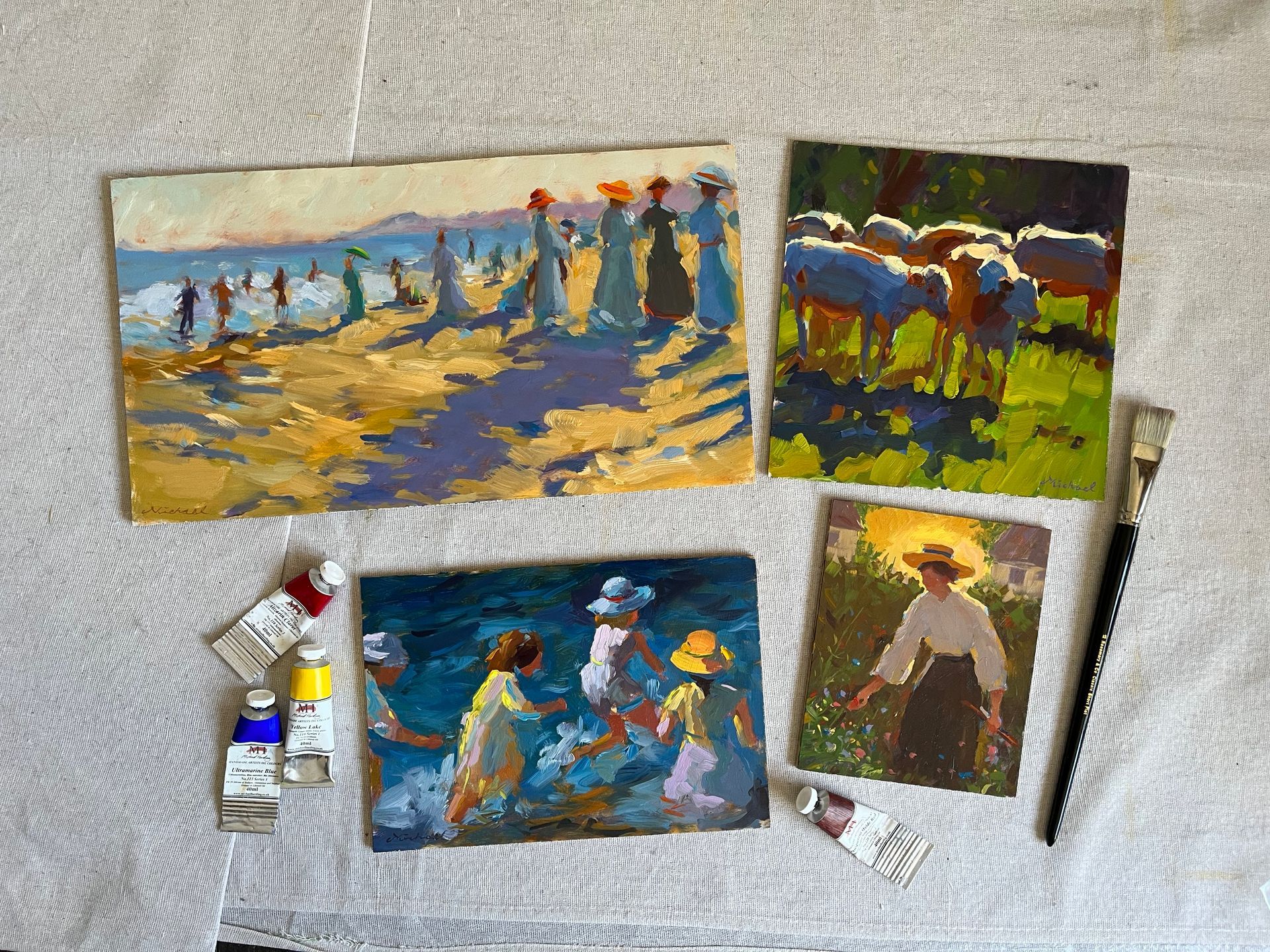 Four impressionist paintings showing various individuals and animals in country style landscape, lying on a white sheet.