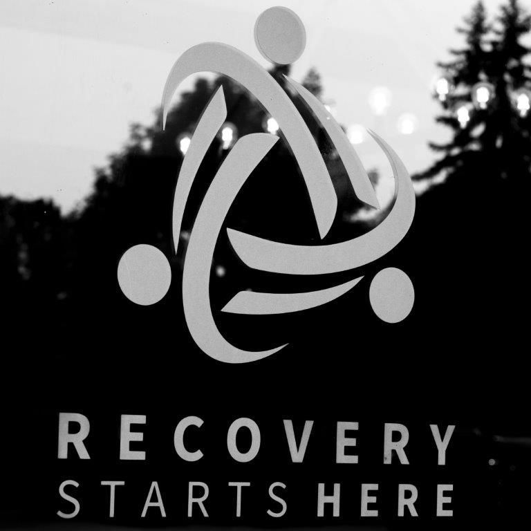 Logo for a recovery center: interconnected shapes with text 