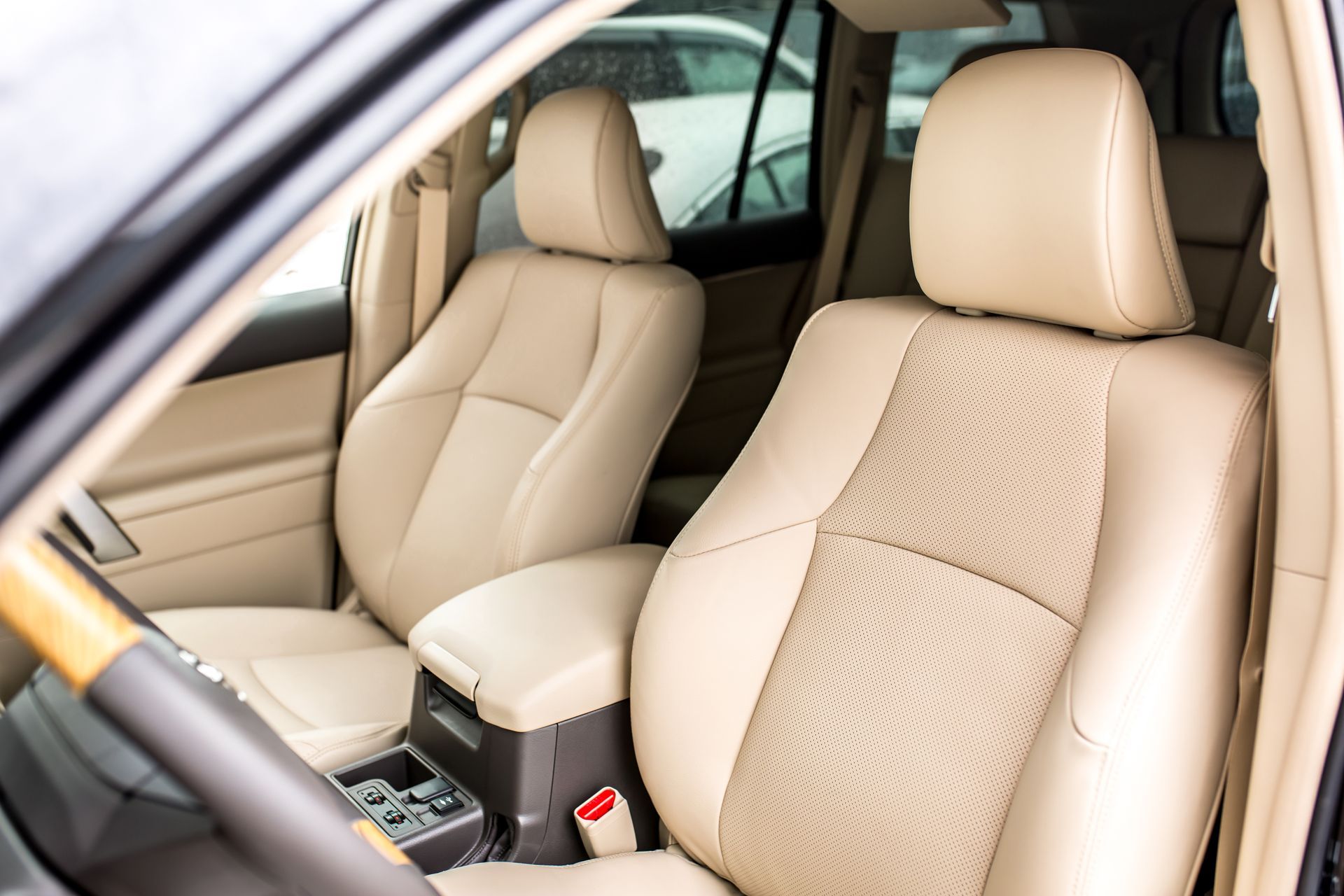 Beige leather car seats and center console inside a vehicle interior