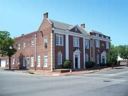 Brick historic building on a corner street under a clear blue sky