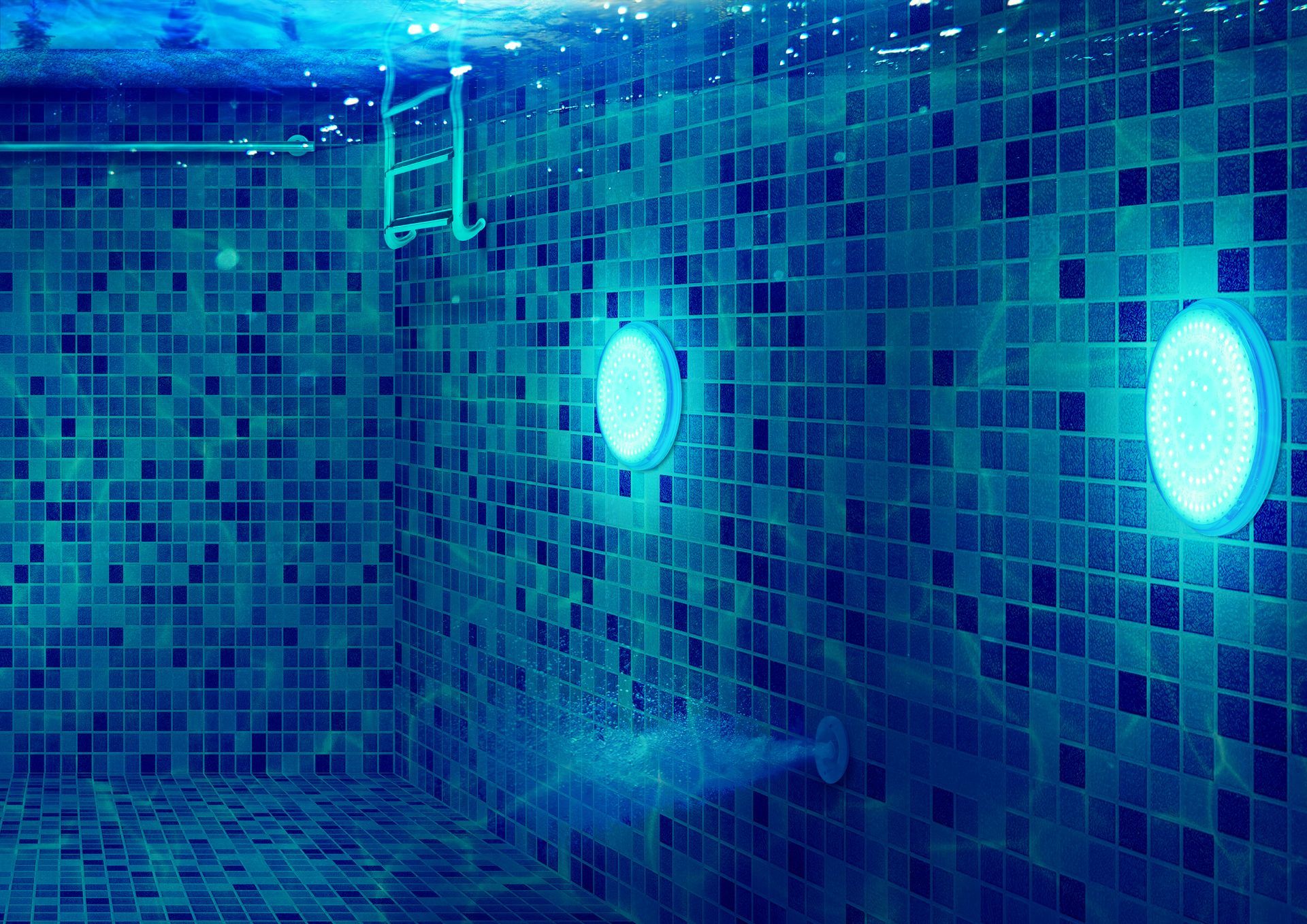 Underwater view of a tiled pool with illuminated lights and a water jet, blue tones.