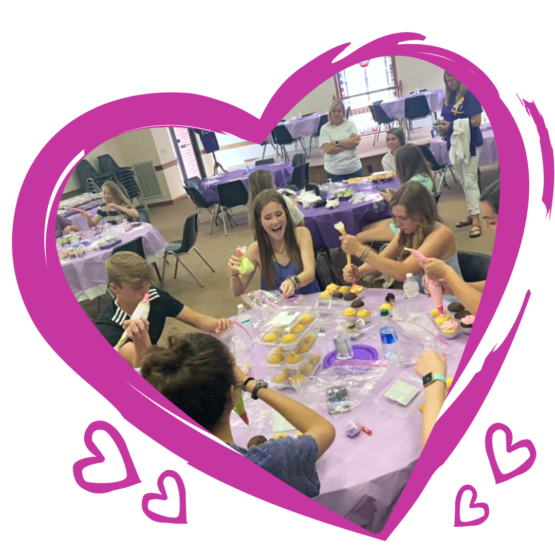 Group Decorating Cupcakes inside Heart Graphic