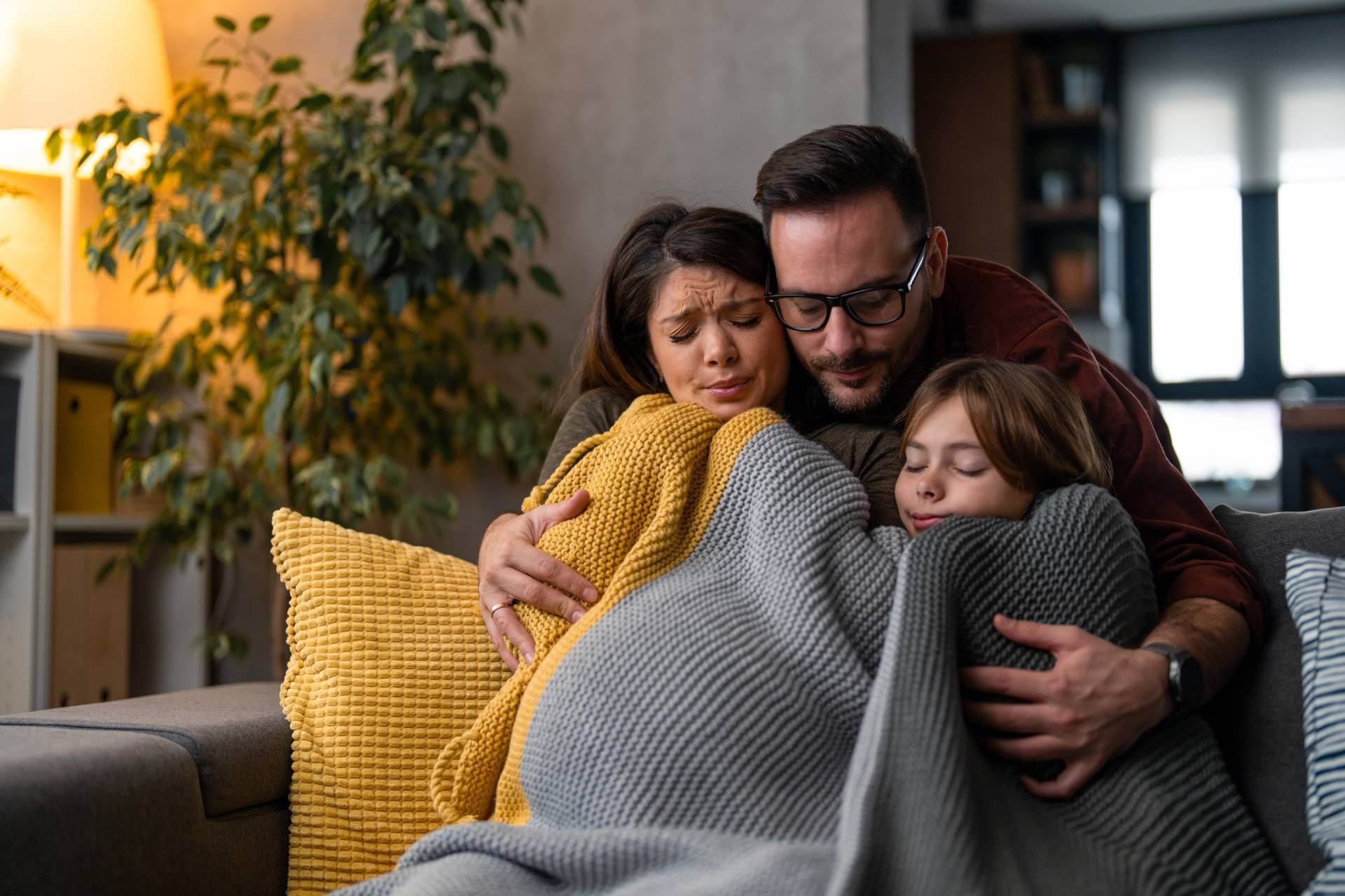 A family huddled together under a blanket for warmth during an HVAC emergency repair near Somerset, 