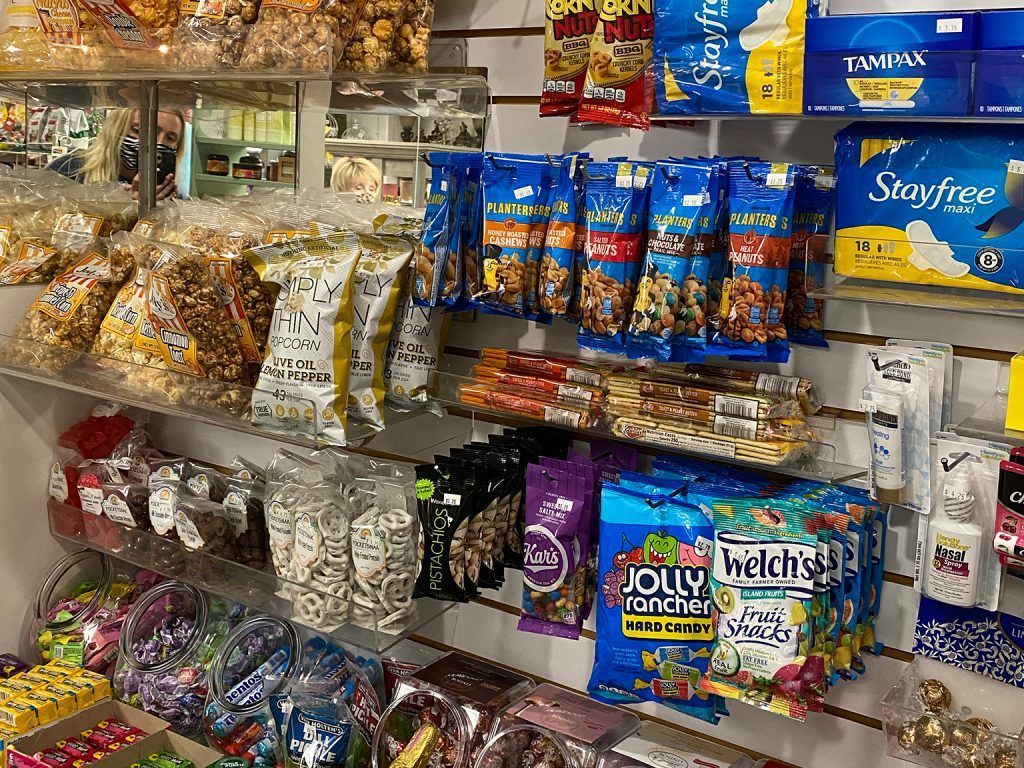 Snack aisle with hanging chips, candy bags, and boxed snacks on store shelves