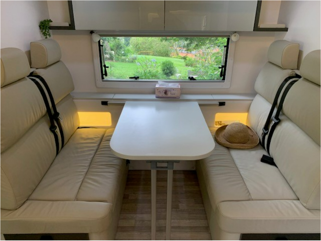 The inside of a camper with a table and a couch