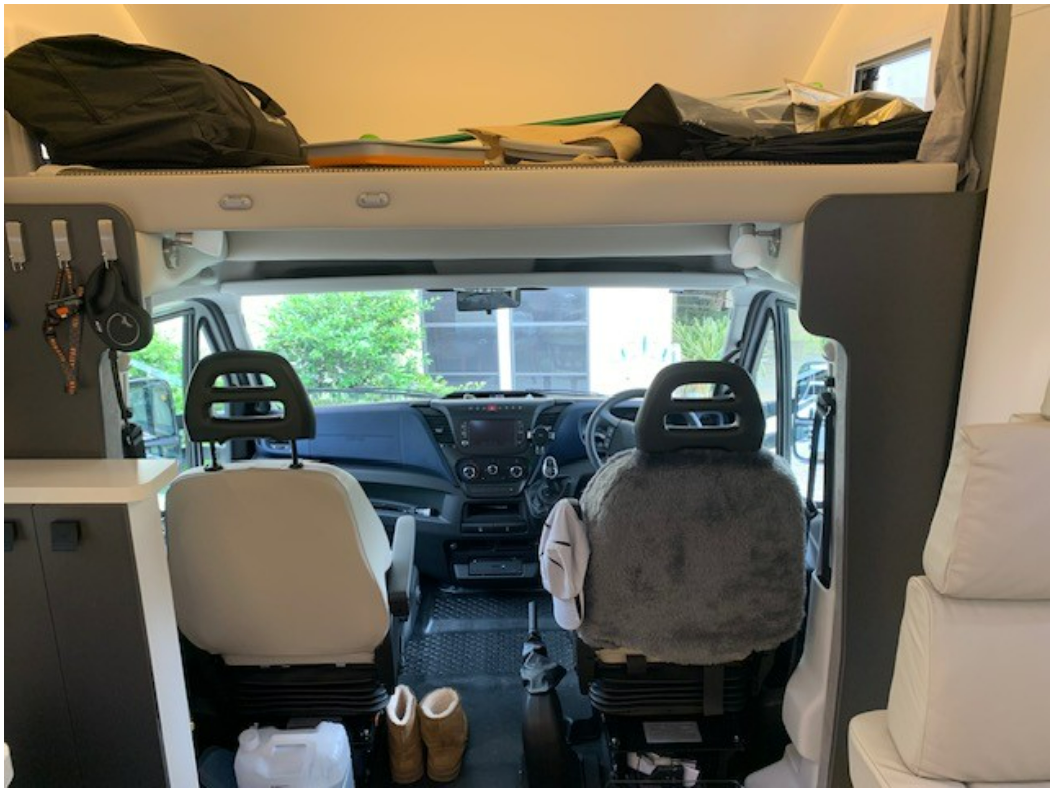 The inside of a camper van with a bunk bed.