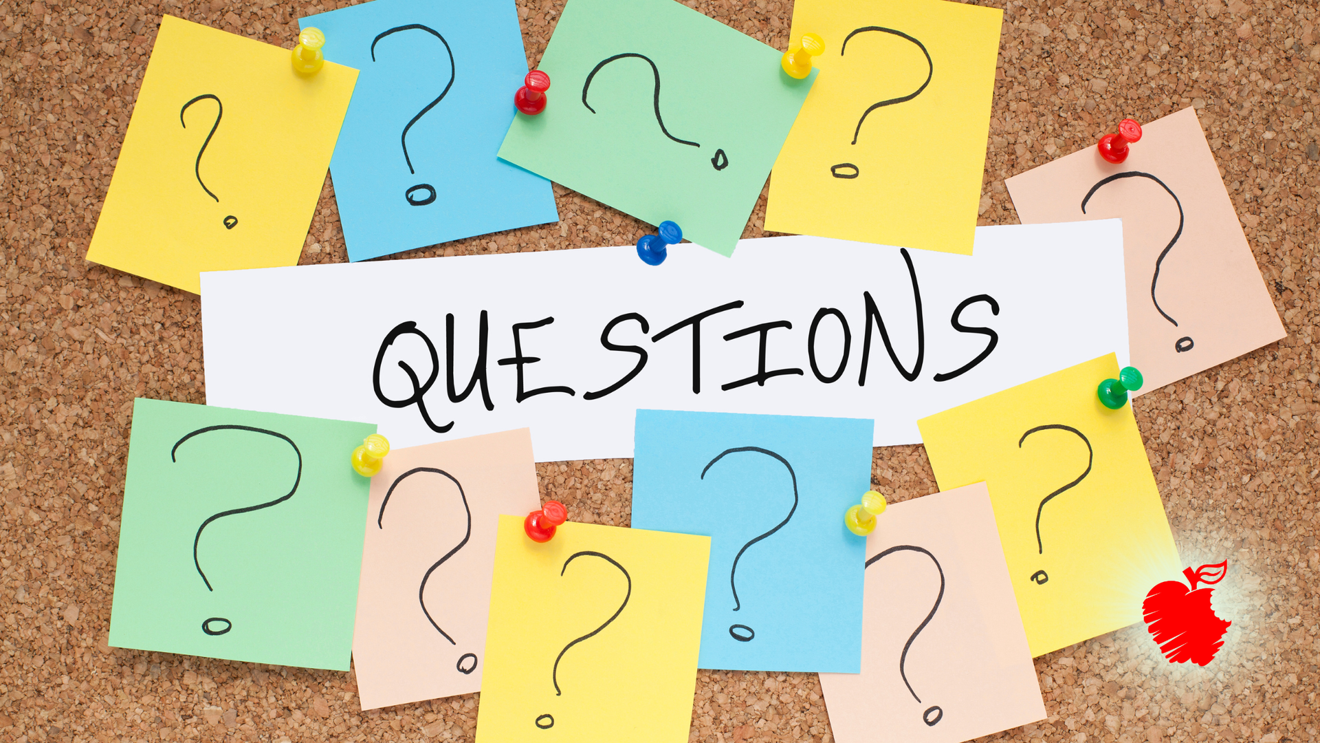 Corkboard with colorful sticky notes, question marks, and the word