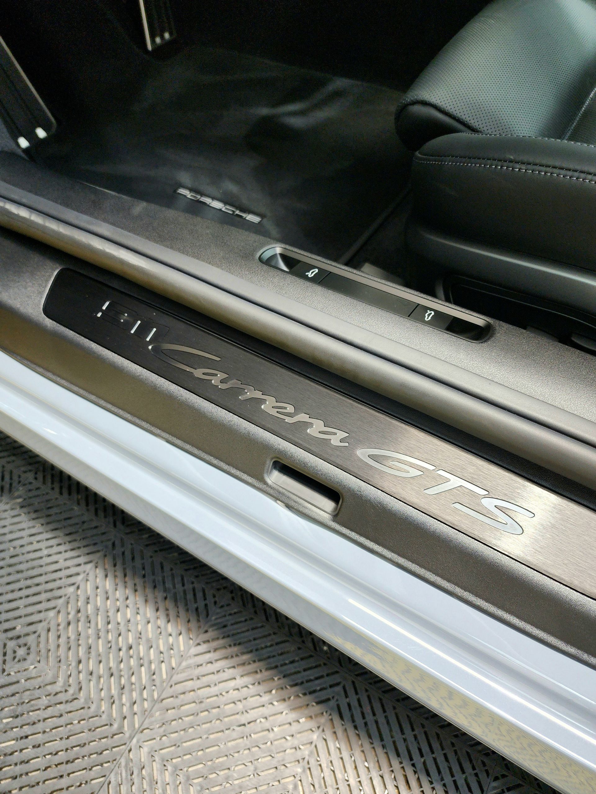 Porsche Carrera GTS door sill with car interior visible.