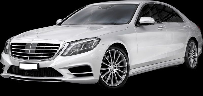 White Mercedes-Benz sedan with black background.