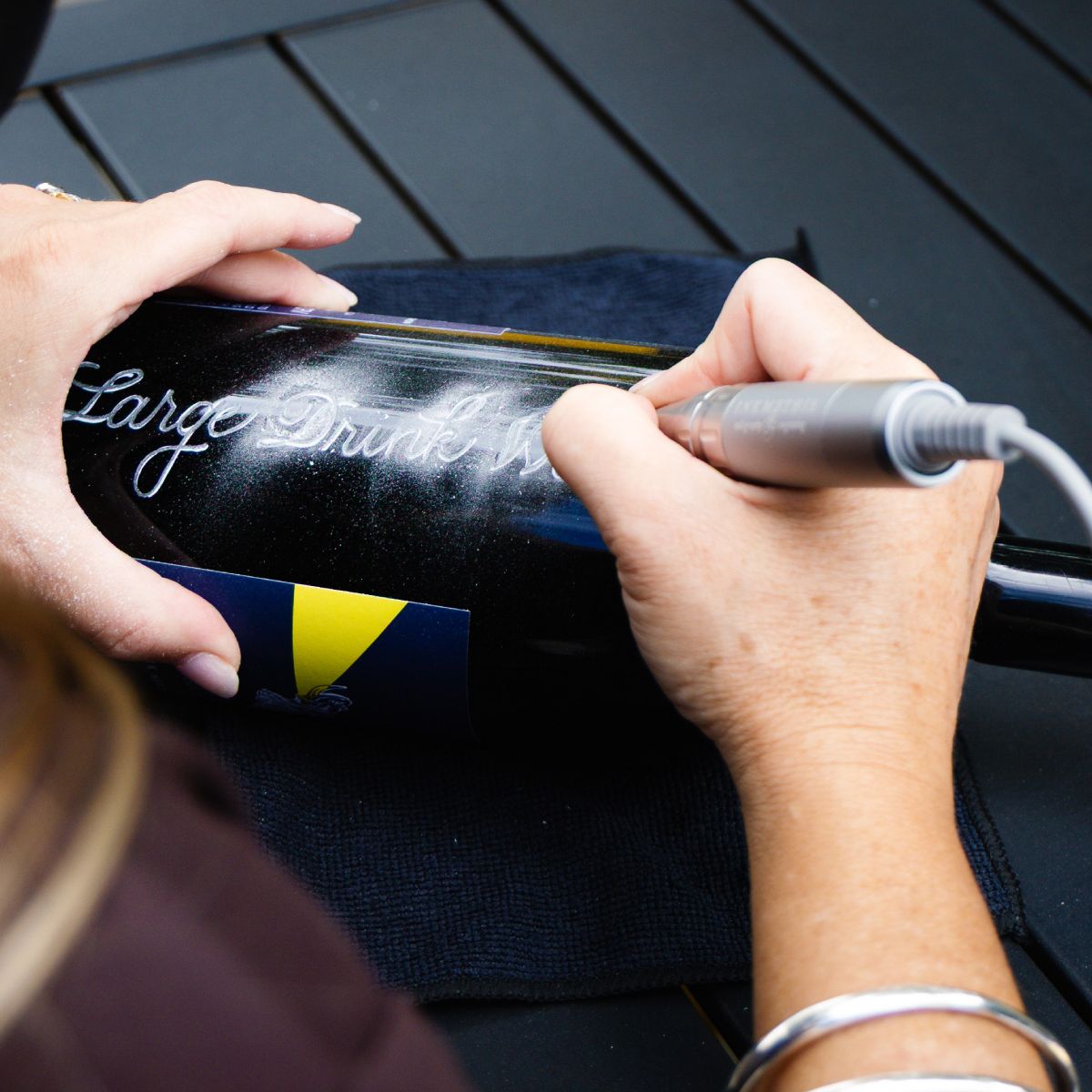 Bottle being engraved