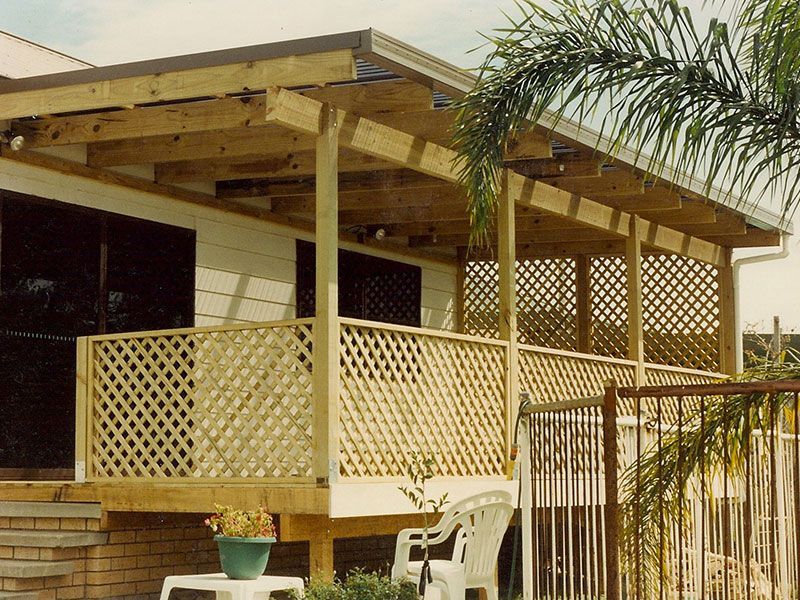 A Porch With A White Railing On The Side Of A House — Newcastle Patio Covers In Wallsend, NSW