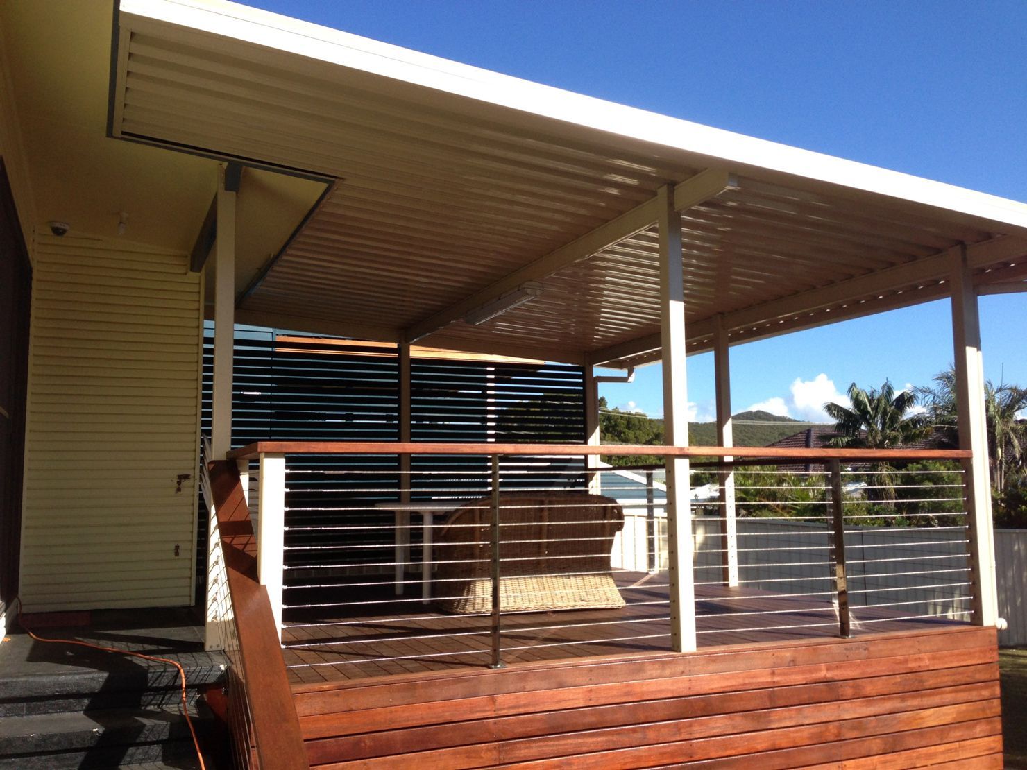 A Car Is Parked Under A Carport In Front Of A House — Newcastle Patio Covers In Wallsend, NSW