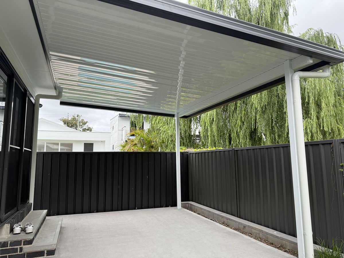 A White And Grey Colourbond Patio Cover With A Dark Grey Fence— Newcastle Patio Covers In Wallsend, NSW