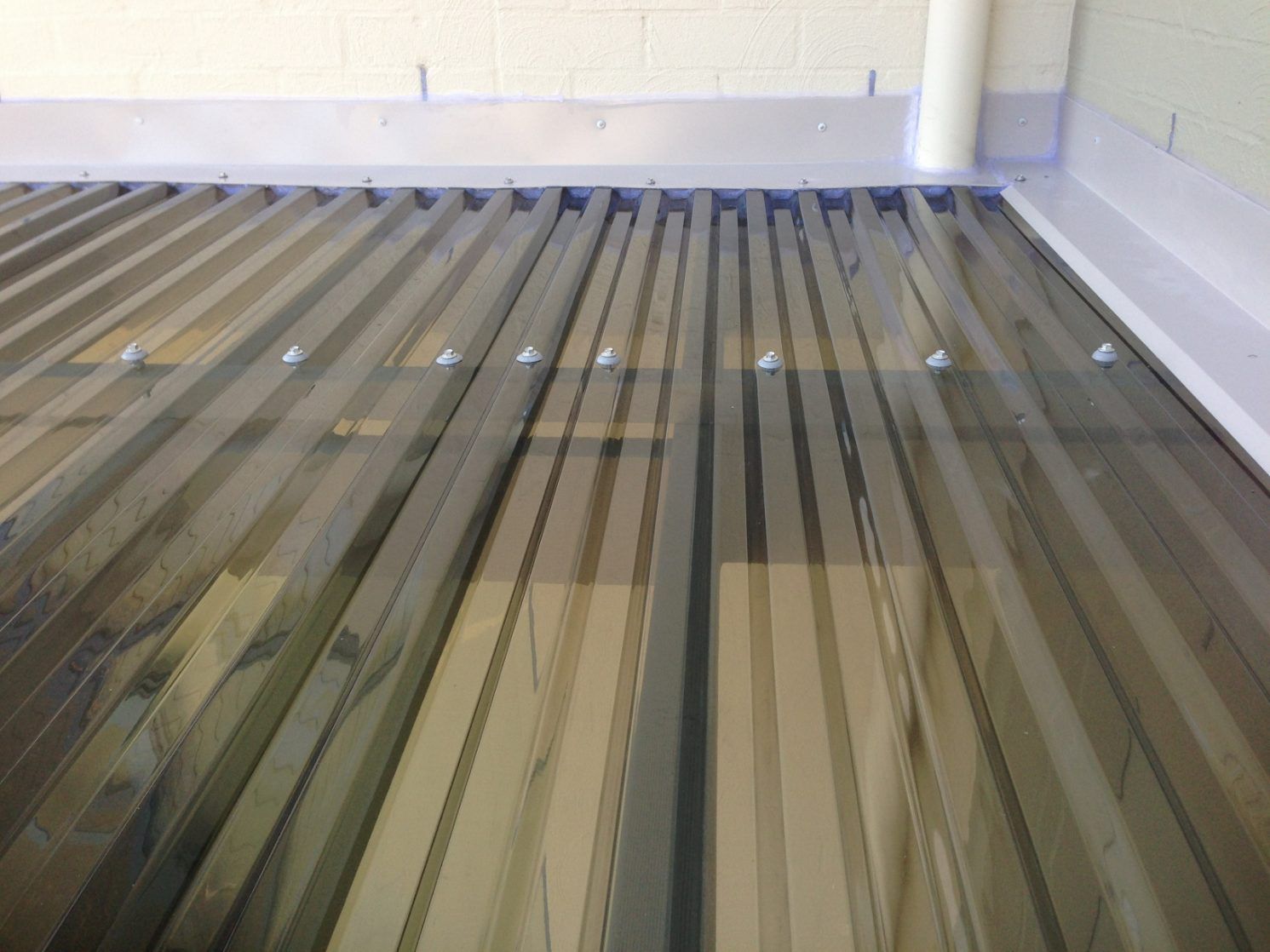 A Close Up Of A Metal Roof In A Building — Newcastle Patio Covers In Wallsend, NSW