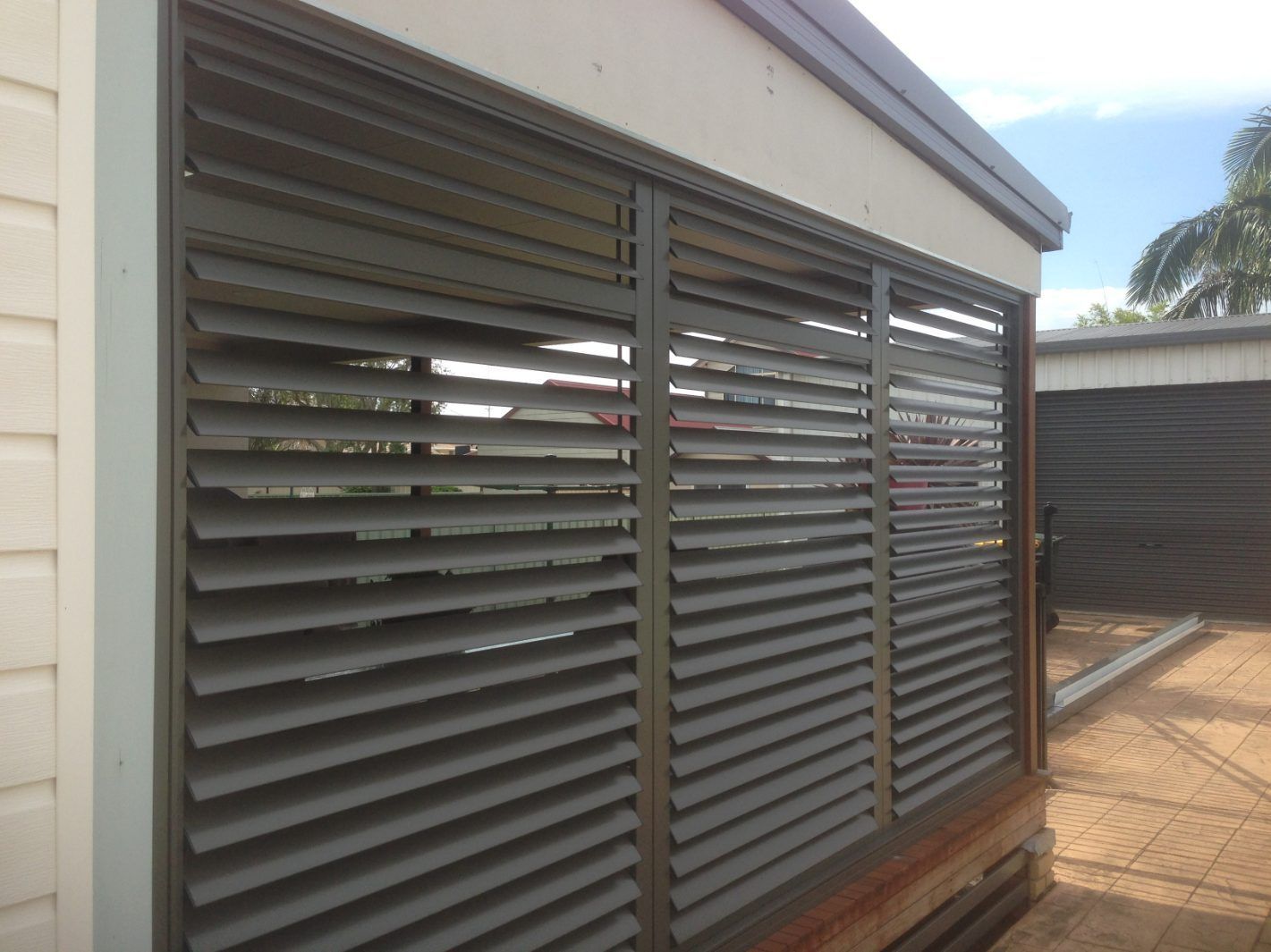 A Building With Shutters On The Side Of It — Newcastle Patio Covers In Wallsend, NSW