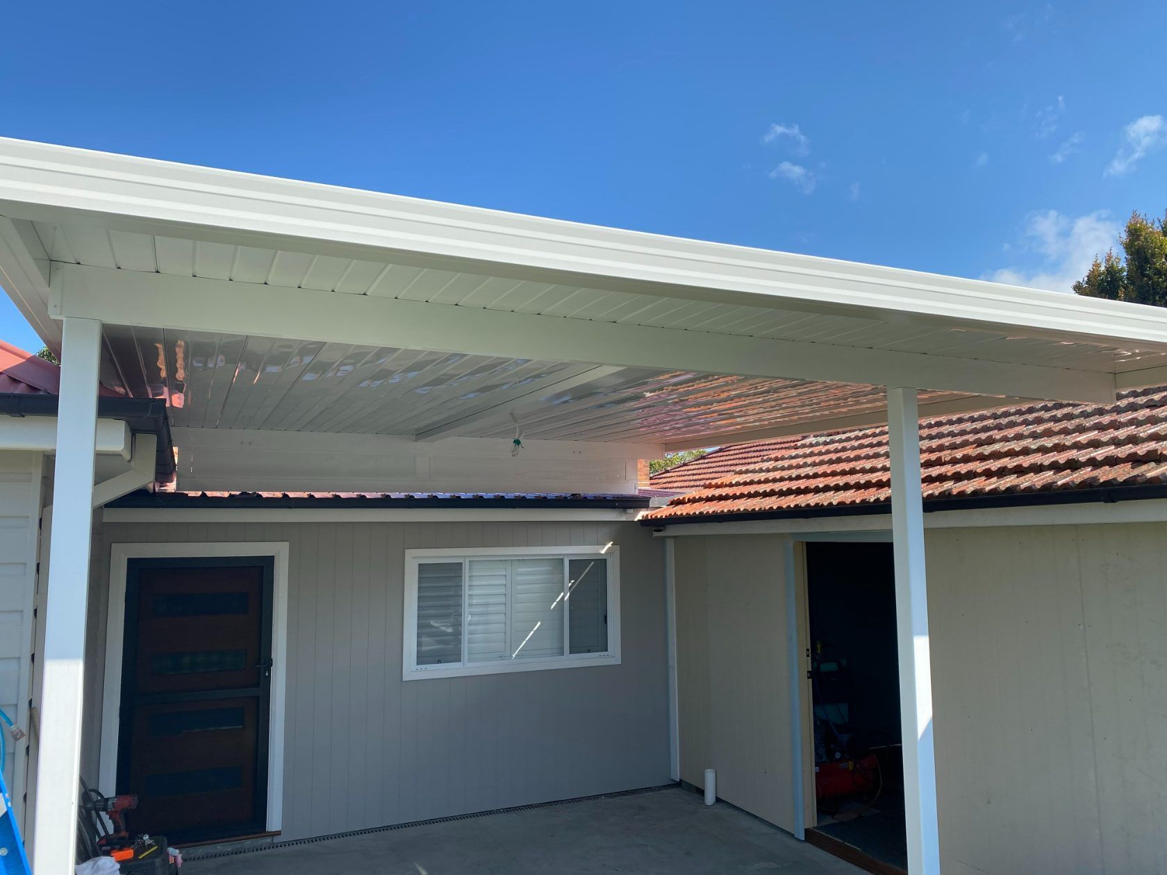 A House With A Carport And A Window On The Side Of It — Newcastle Patio Covers In Wallsend, NSW
