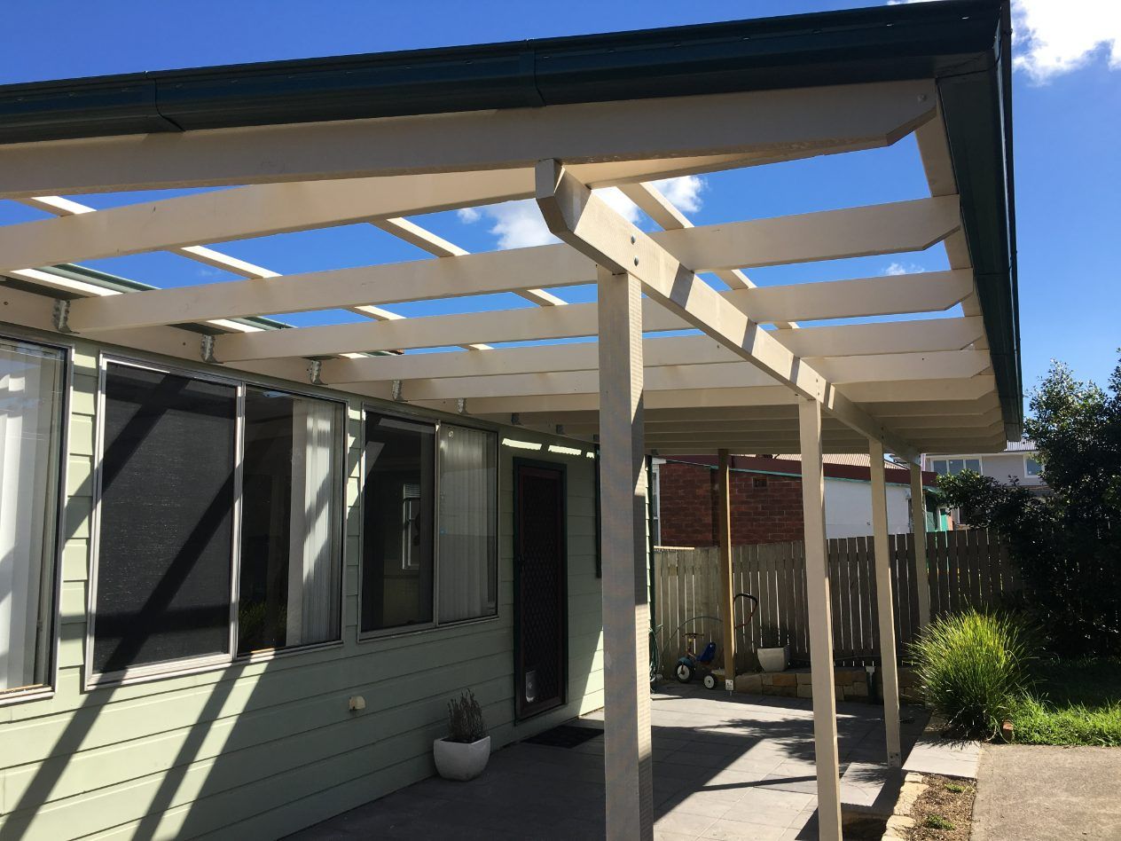 A House With A White Pergola On Top Of It — Newcastle Patio Covers In Wallsend, NSW