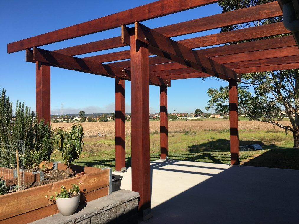 A Wooden Pergola With A View Of A Field — Newcastle Patio Covers In Wallsend, NSW