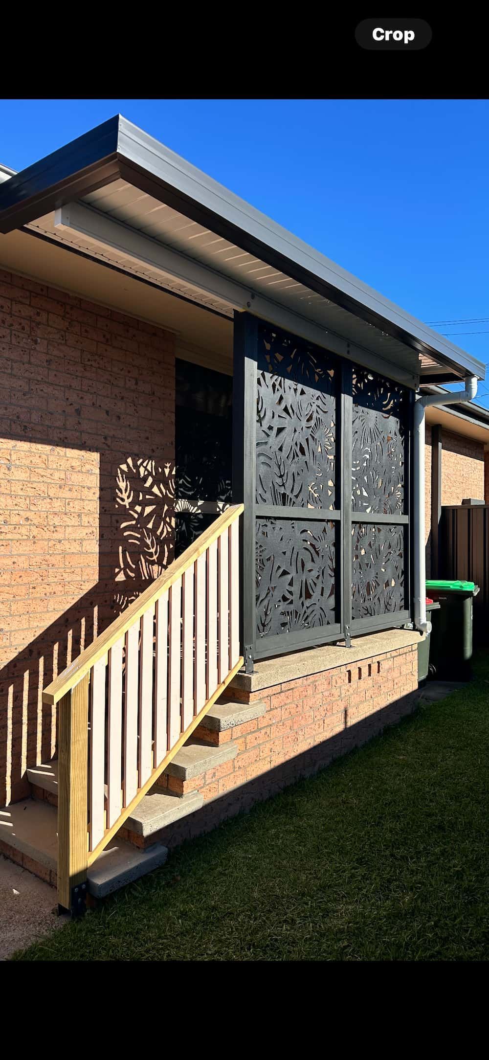A Covered Entrance Way With Stairs And Black Metal Cut Out Screen — Newcastle Patio Covers In Wallsend, NSW