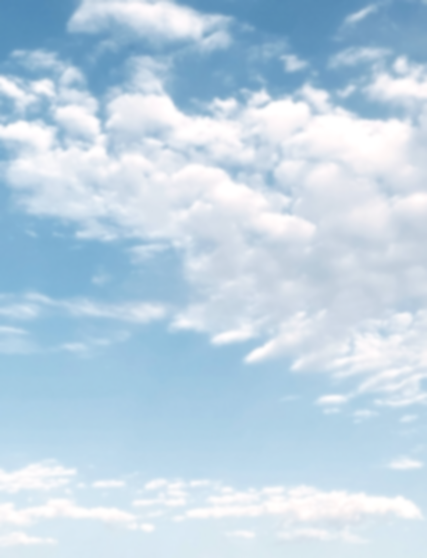 Light blue sky filled with scattered, soft white cumulus clouds.