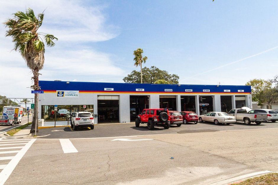 Convenience store gas station with parked cars on a sunny day | Charlie's Car Care