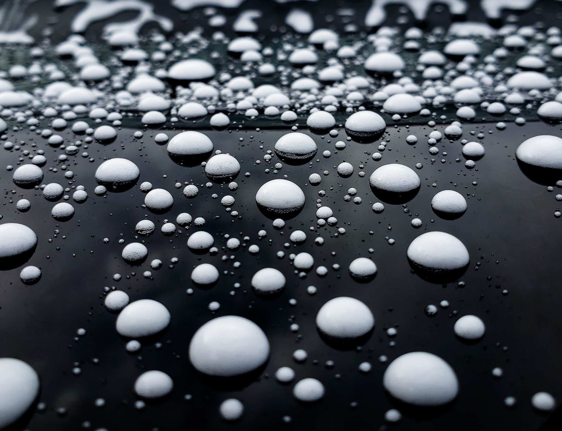 soap beads on car paint during a car wash with a ceramic coated vehicle