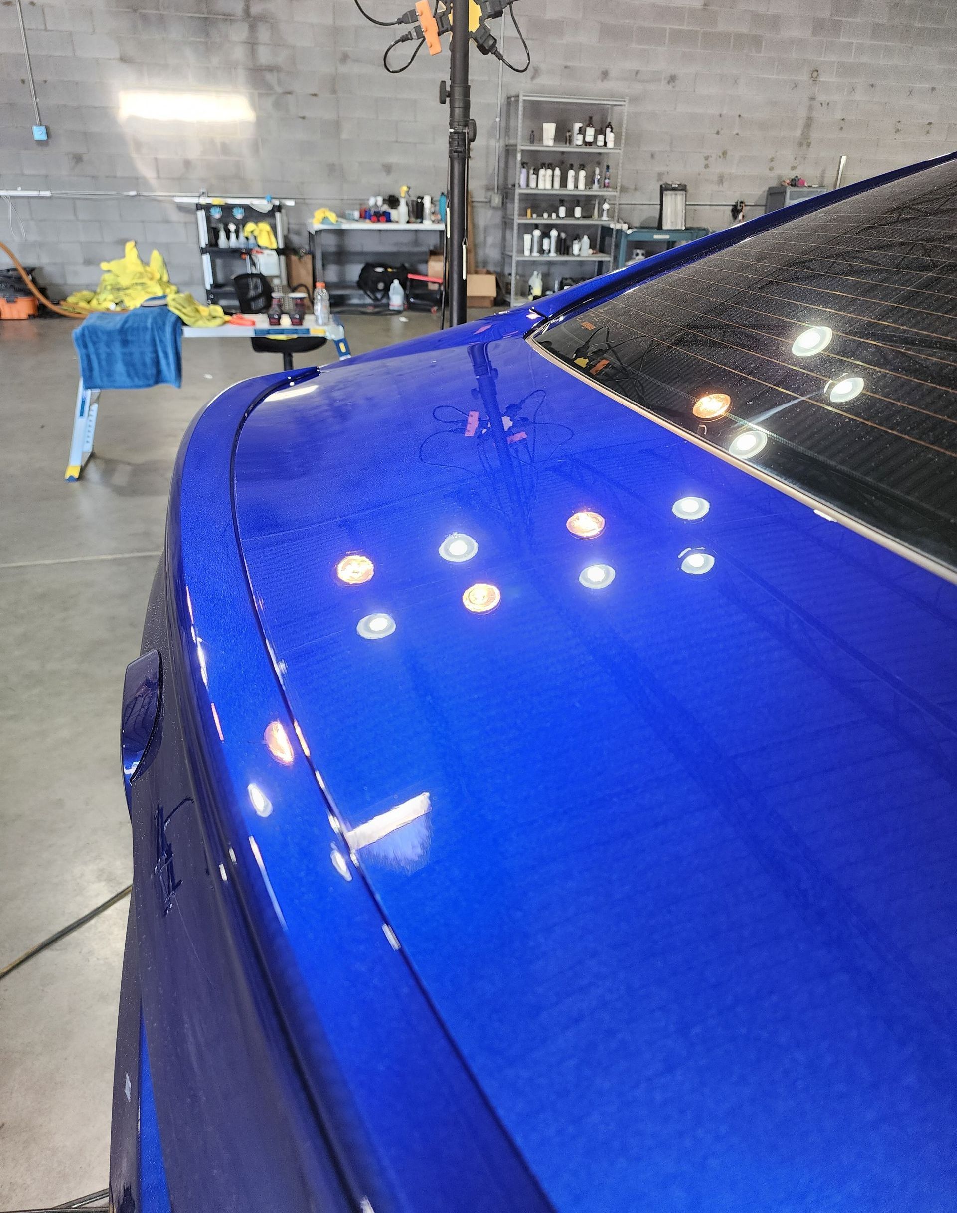A close up of a blue car in a garage