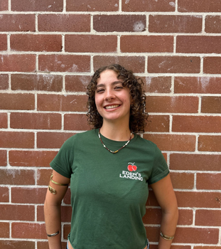 Eden’s Landing team member smiling warmly, showcasing the community-focused spirit of a local organic grocer in Mullumbimby.